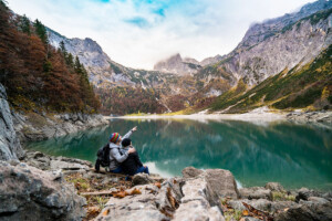 Couple resting at a lake on their hike up the Colorado 14er Mount Shavano