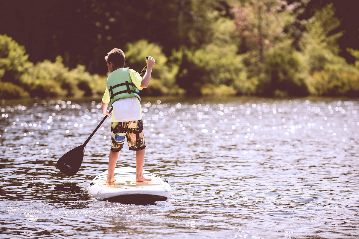 Boy paddleboarding on a lake near Salida Colorado