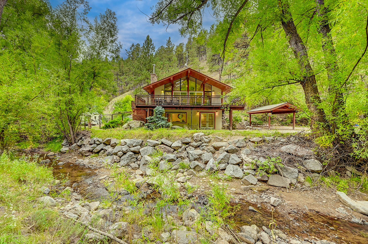 Fourmile Creek running along the A-Chalet creekside home rental near Boulder