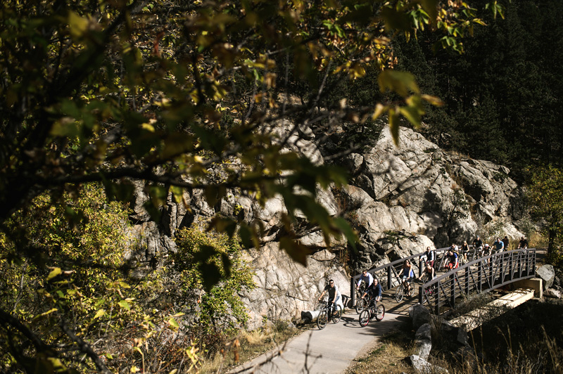 Wedding guests biking in Boulder Canyon during adventure destination wedding weekend at A-Lodge Boulder Colorado