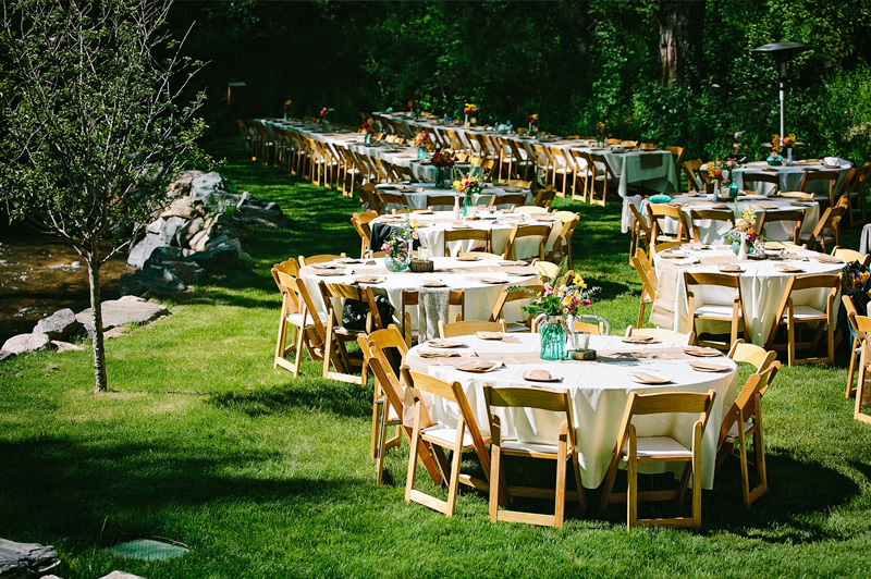 Creekside outdoor wedding reception setup at A-Lodge Boulder Colorado destination wedding venue