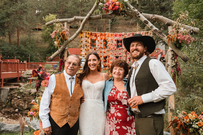 Bride celebrating with family at A-Lodge Boulder Colorado destination wedding ceremony arch