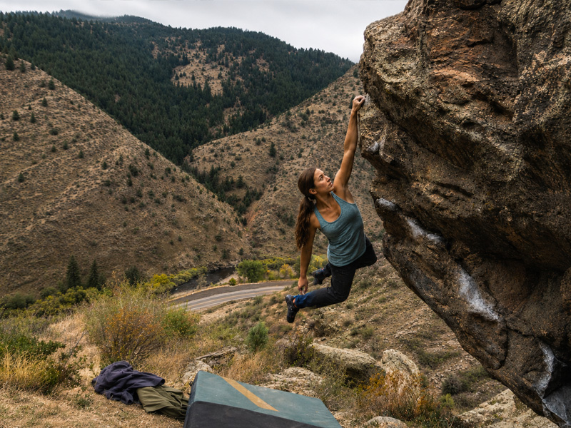 woman bouldering in Clear Creek Canyon staying in the hostel room at the A-Lodge