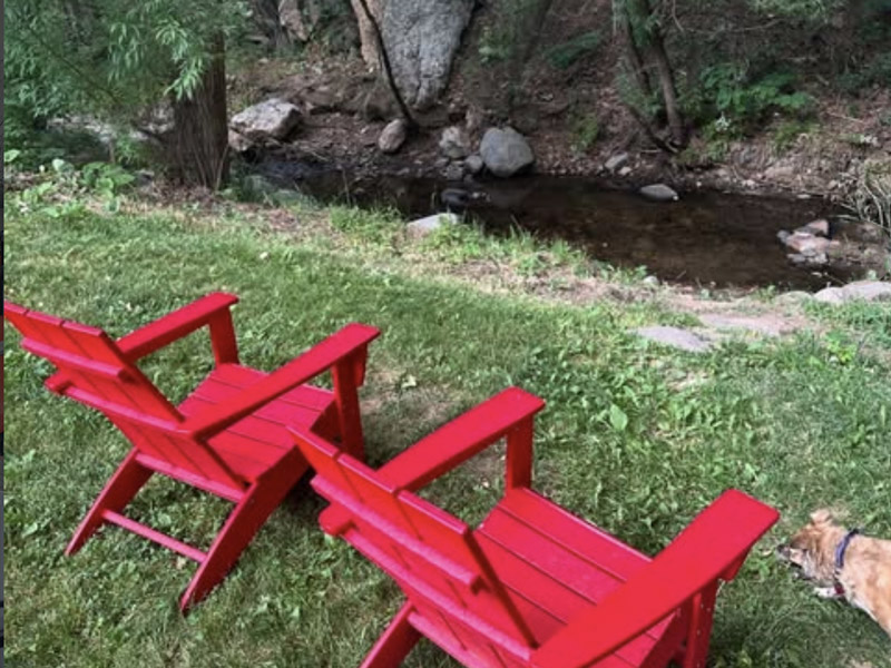two chairs by a creek at the A-Lodge hotel in Boulder, Colorado