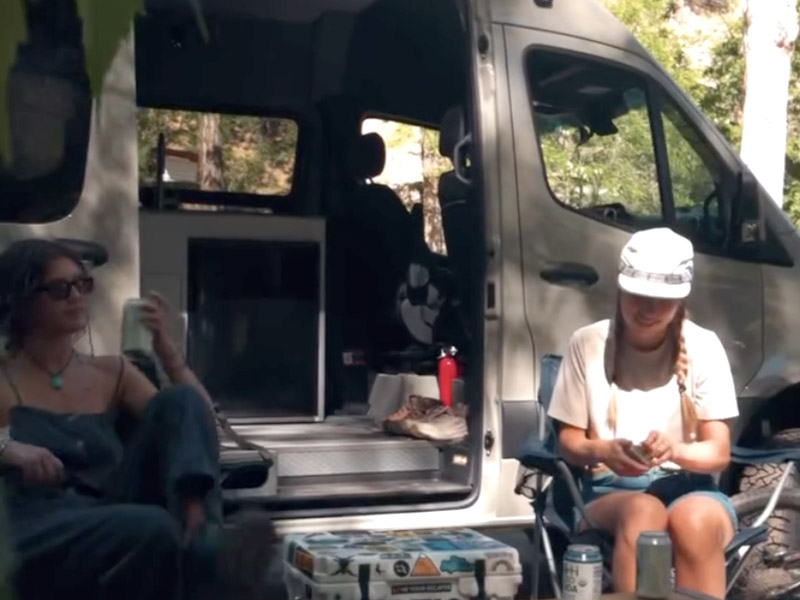 Two vanlife woman with their mountain bikes staying at the A-Lodge van camping sites